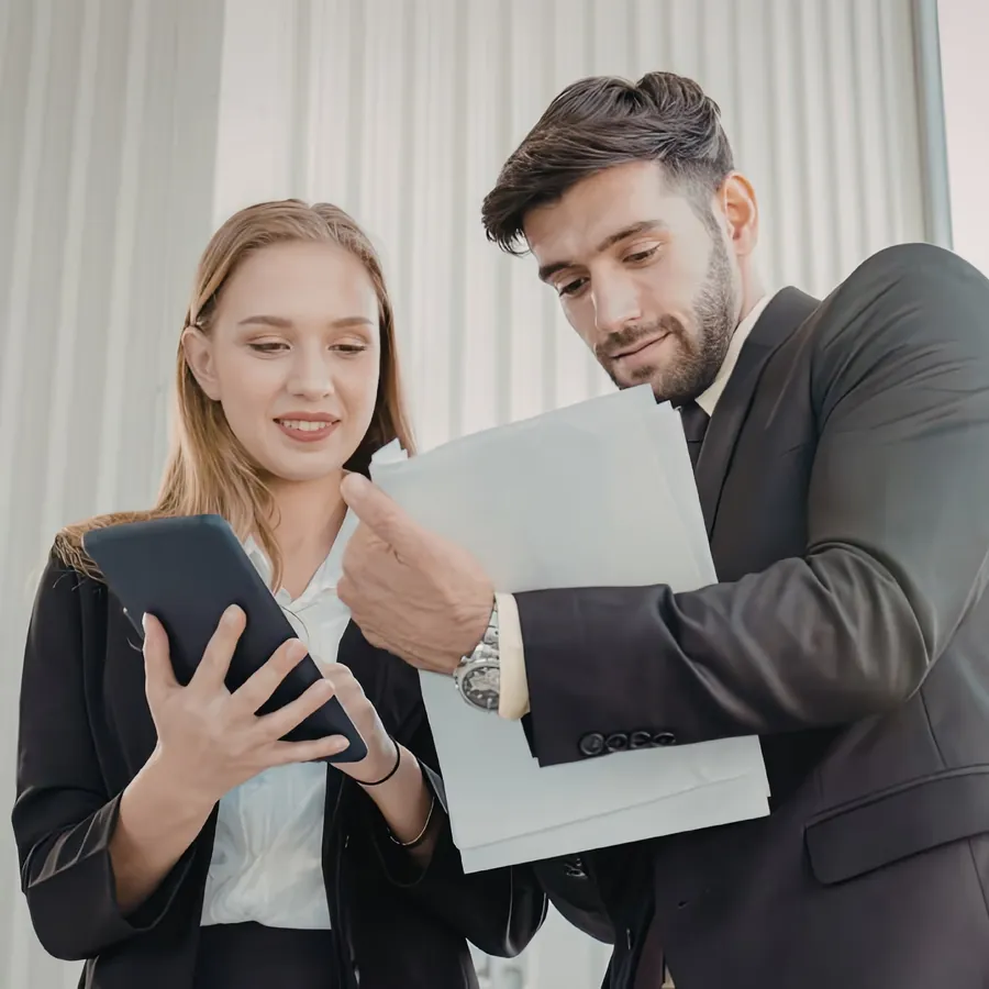A woman showing a tablet to a colleague